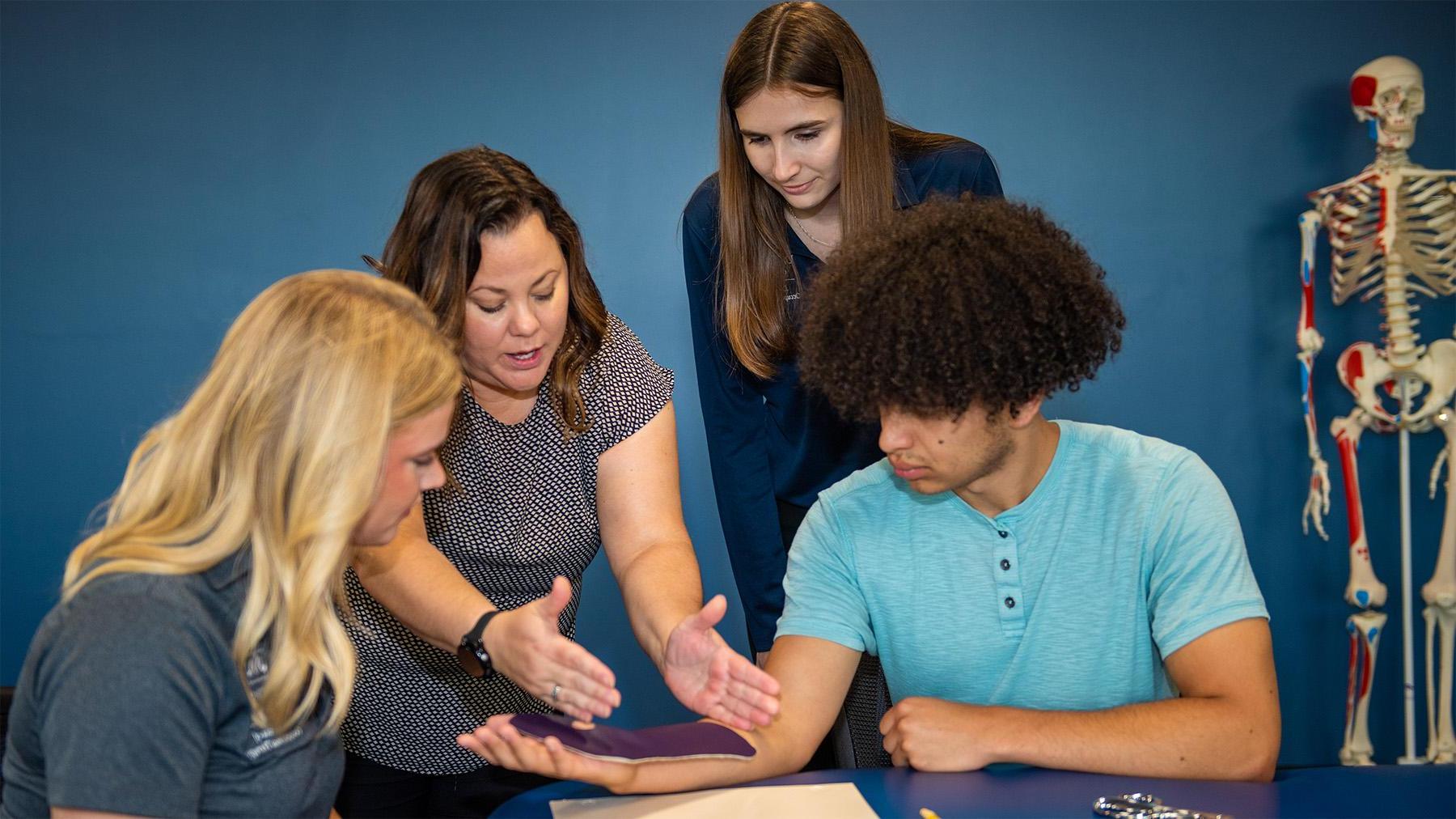 students learning how to properly wrap an arm brace.